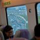 Travelers sit on the Airport Express train as vehicles are clogged with heavy traffic heading to the airport during a protest at the Hong Kong International Airport, Aug. 12, 2019.